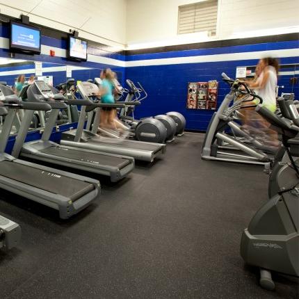 学生 using cardio machines including a stationary bike and treadmill